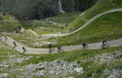 cyclists riding up mountain pass