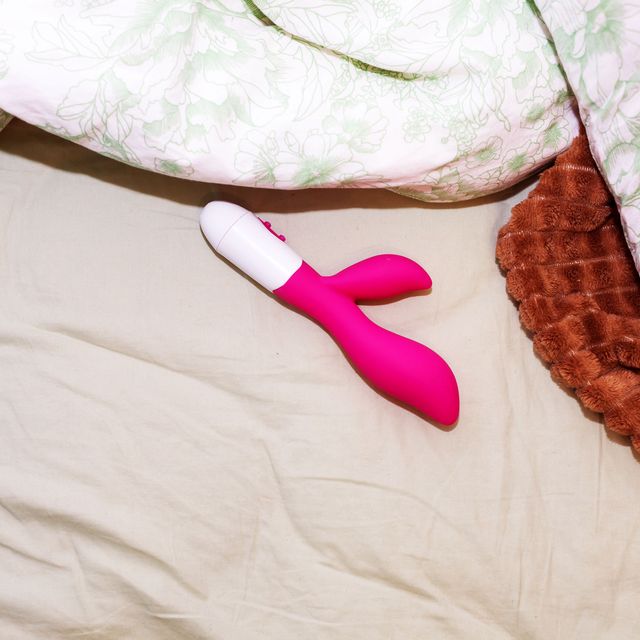 a pink rabbit vibrator on a bed