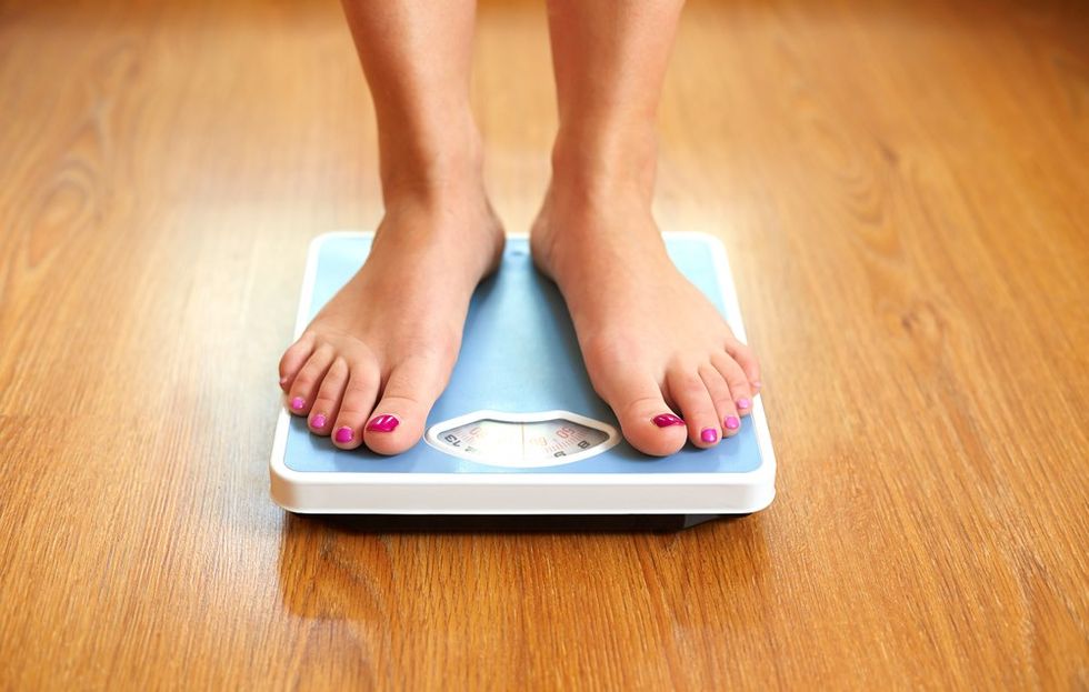 Weight loss standing on bathroom scale