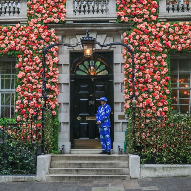 mandatory credit photo by amer ghazzalshutterstock 10241068ba doorman stands in front of annabel's private club in london mayfair whose facade is decorated with flowers to mark the chelsea flower showannabel's club flower facade, berkeley square, london, uk 19 may 2019