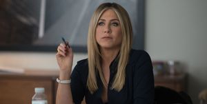 jennifer aniston at a desk in an office
