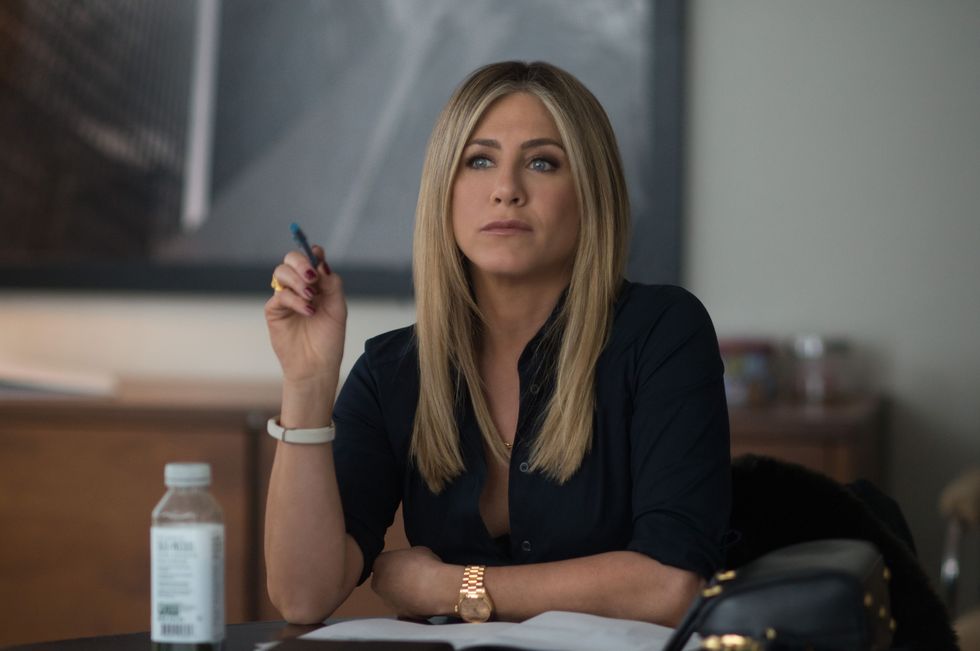 jennifer aniston at a desk in an office
