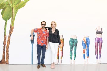 a couple posing with colorful leggings on display