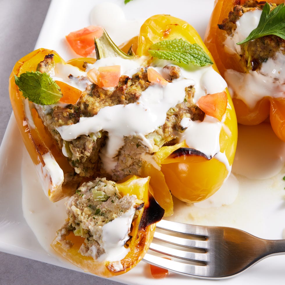 multicolored peppers stuffed with shawarma and drizzled with a cream sauce and mint