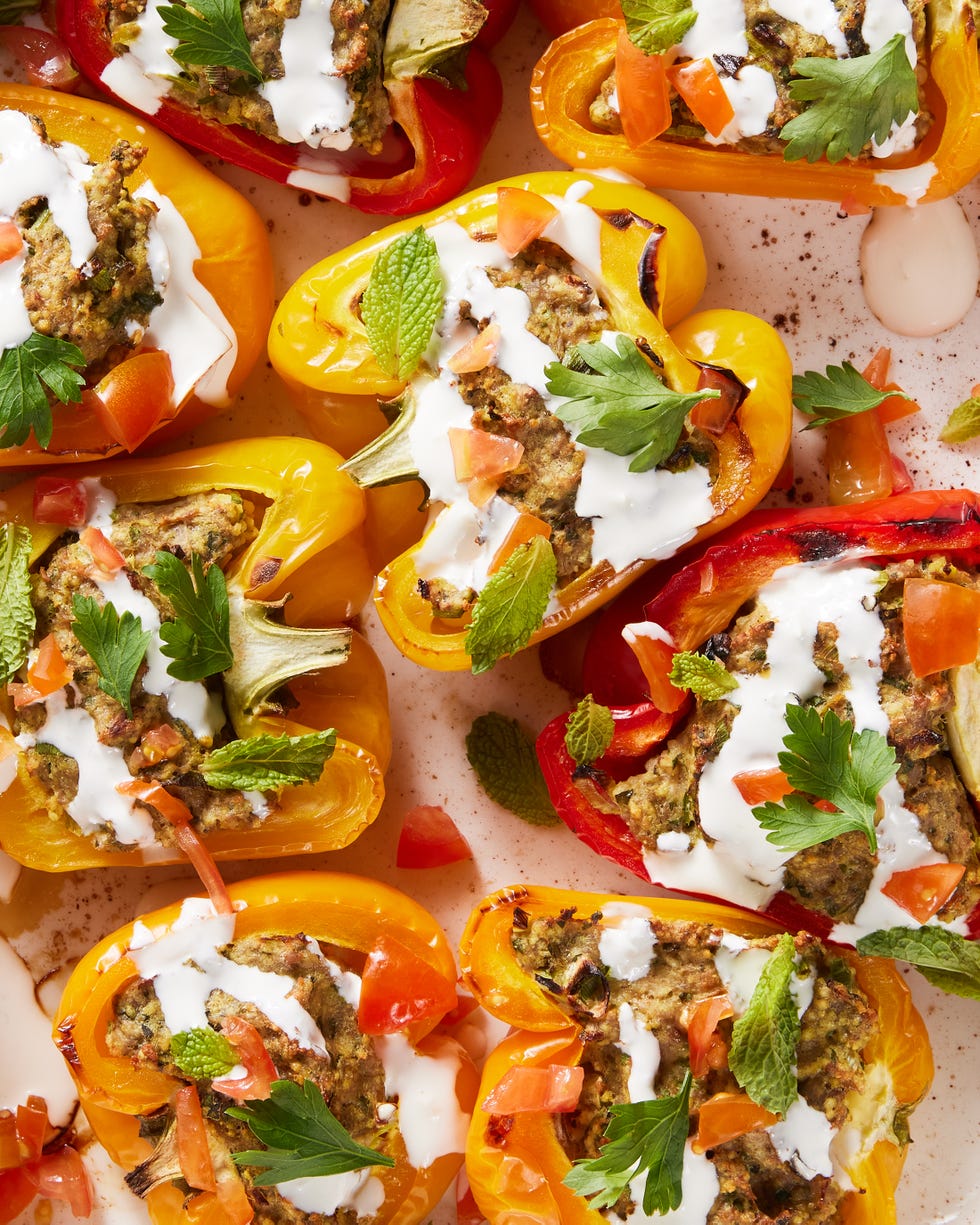 multicolored peppers stuffed with shawarma and drizzled with a cream sauce and mint