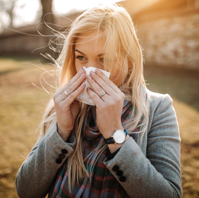sick blonde blowing her nose