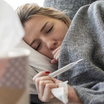 can you sweat out a fever  sick woman with flu at home