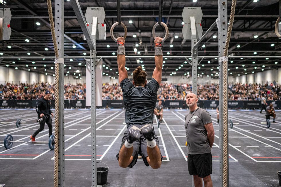 an athlete performs ring muscle ups at strength in depth 2022