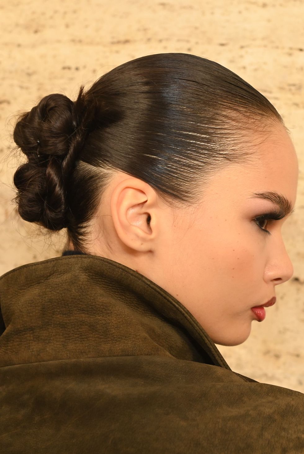 a woman with her hair pulled back
