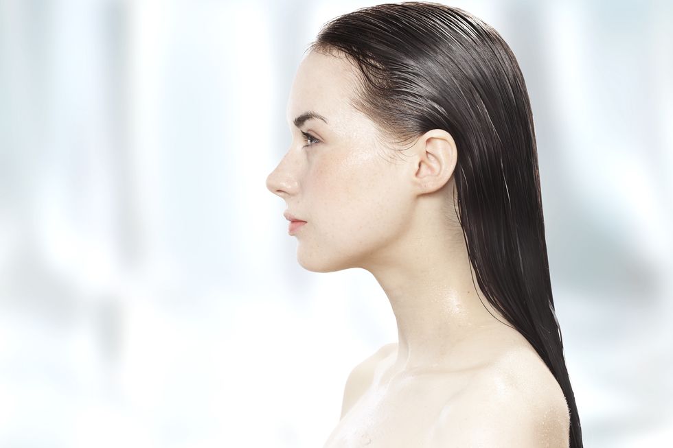 side profile of a young woman with her hair wet