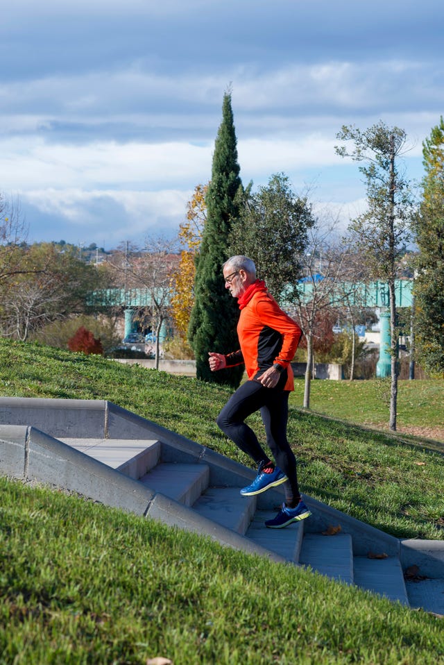 Side View Of Senior Man Running On Steps In Park