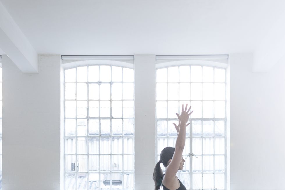 side view of woman in dance studio in yoga position