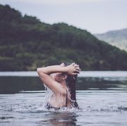 Side View Of Woman Swimming In Lake
