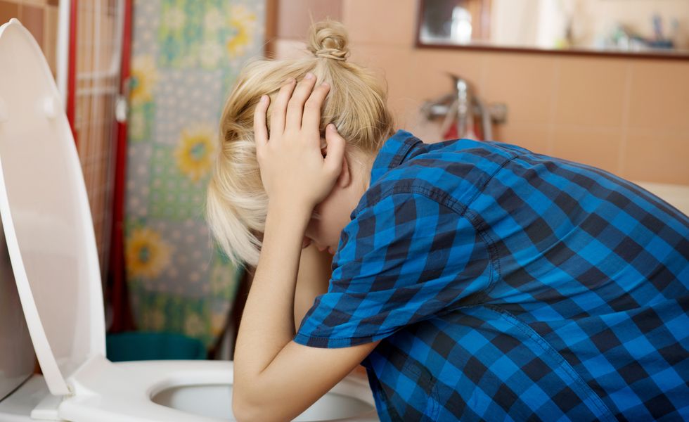Side View Of Young Woman Leaning On Toilet Bowl