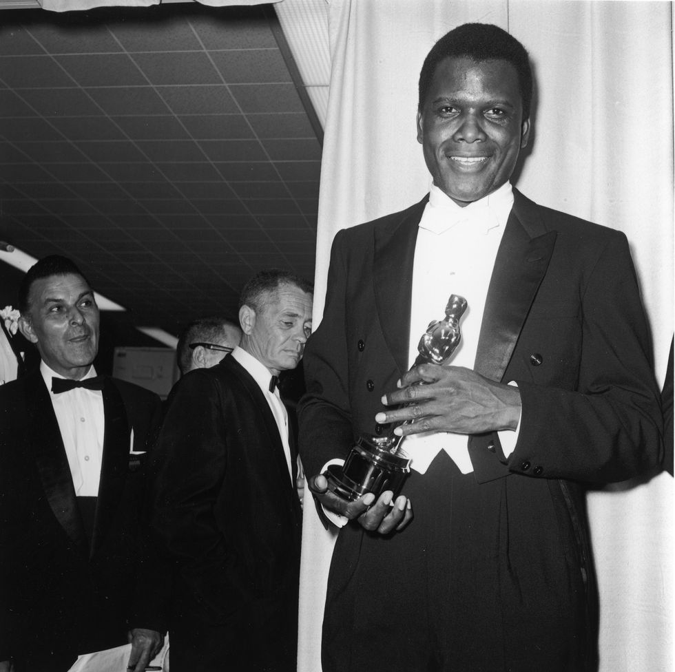 Sidney Poitier holds his Best Actor Oscar for director Ralph Nelson's film 'Lilies of The Field' backstage at the Academy Awards ceremony in Santa Monica, California
