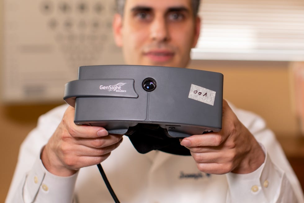 scientist holding gensight goggles