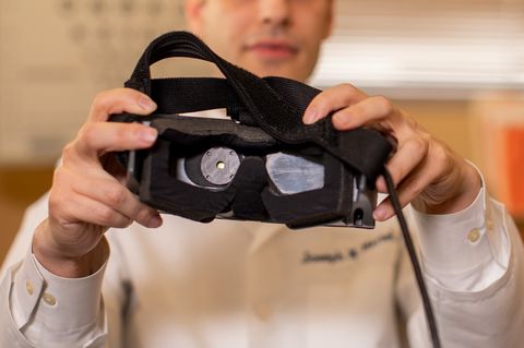 scientist holding gensight goggles