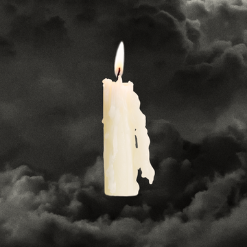 a white candle with a flame