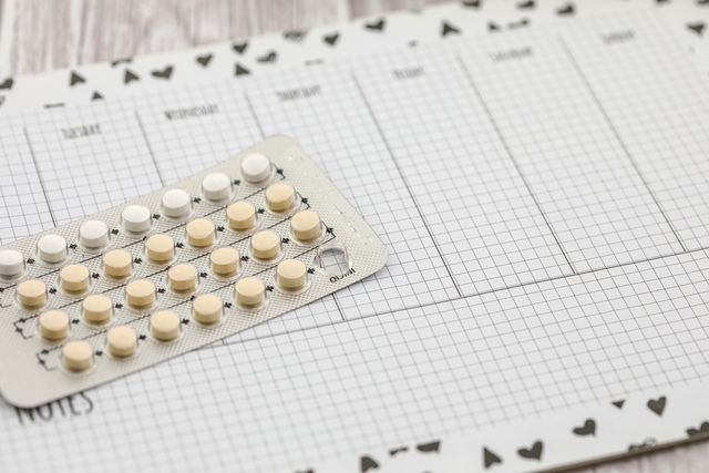 Contraceptive pills on a calendar.