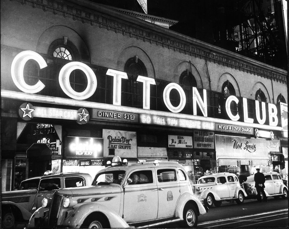 signs outside the cotton club at night