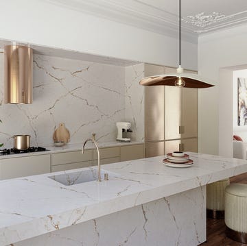 a white bathtub with a white tablecloth and a chandelier