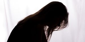 silhouette of a young woman with problems