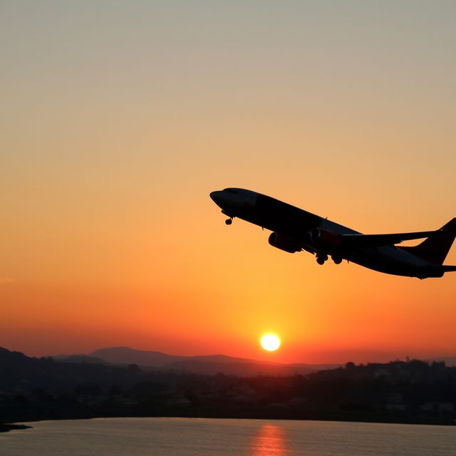 Silhouette of an airplane just after take off during sunset