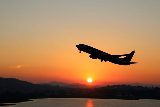 Silhouette of an airplane just after take off during sunset