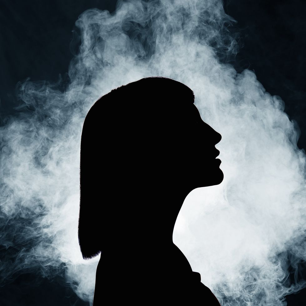 silhouette of woman with smoke