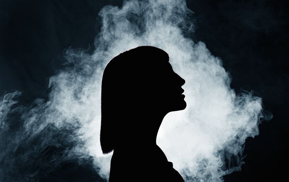 silhouette of woman with smoke