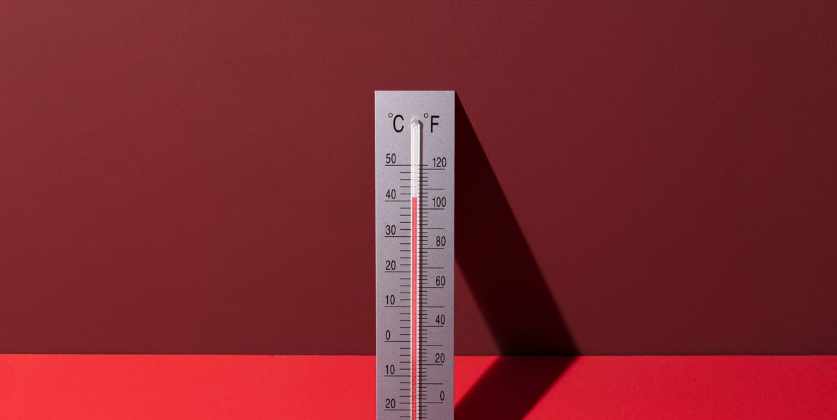 silver thermometer shows high temperature on red background
