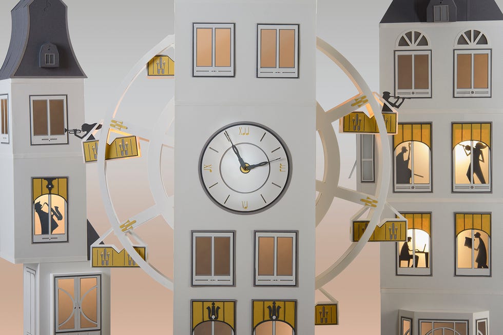 un reloj y edificios en blanco hechos de papel de mila garcia en joyeria montiel