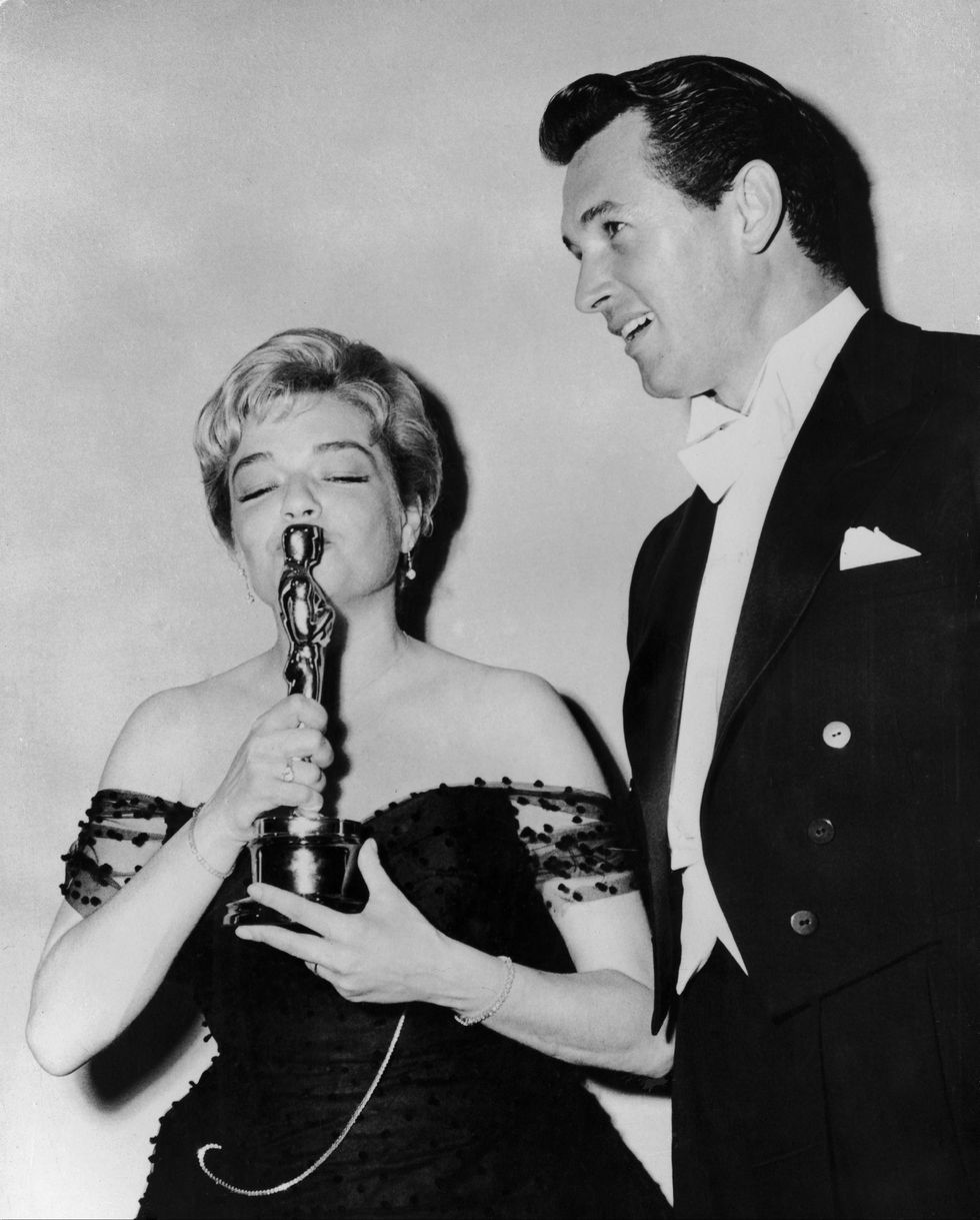 simone signoret receiving the oscar for best actress beside rock hudson in 1960
