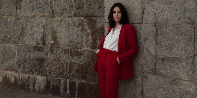Woman in red pantsuit  walking in the city