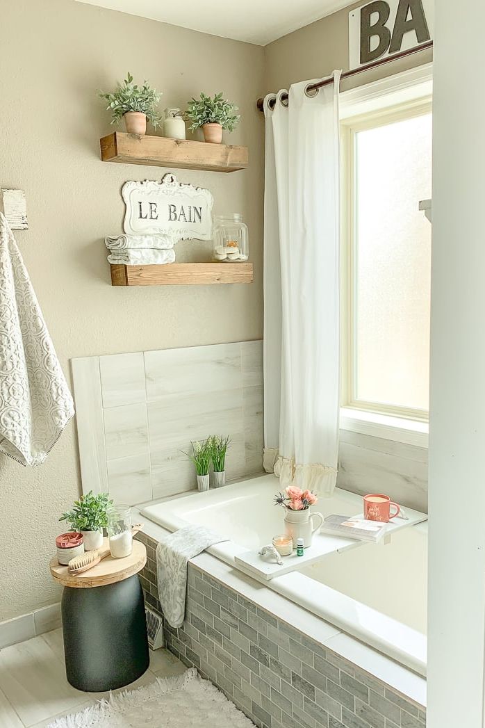 bathroom with wood shelves over tub