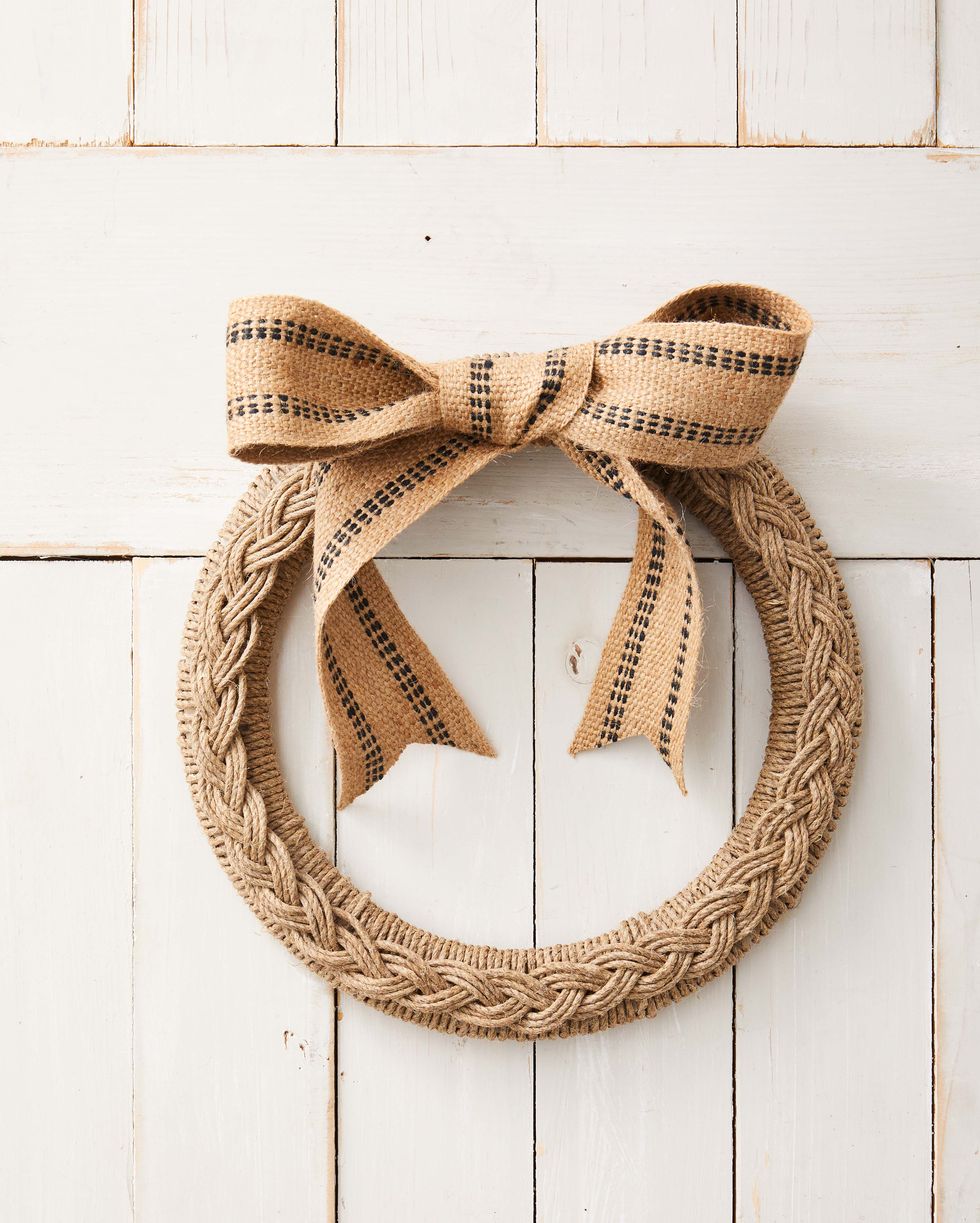 wreath form wrapped in twine topped with a braid made from teh same twine
