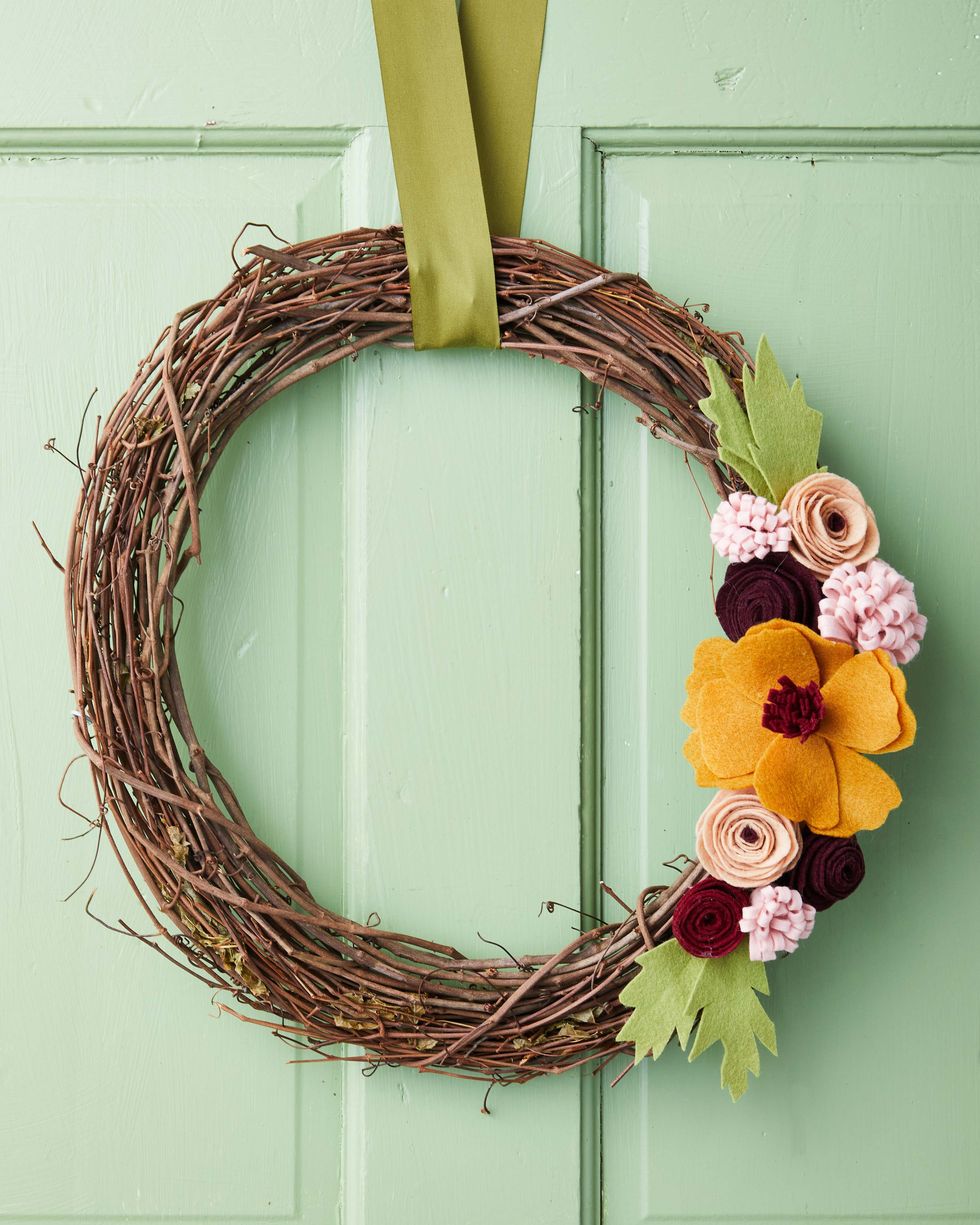 felt flowers and leaves on a grapevine wreath form