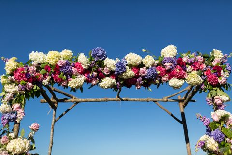 simple wooded garden archway decorated with floral garland