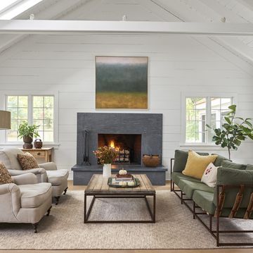 a living room with a large artwork hanging over the fireplace