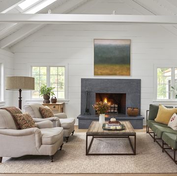 a living room with a large artwork hanging over the fireplace