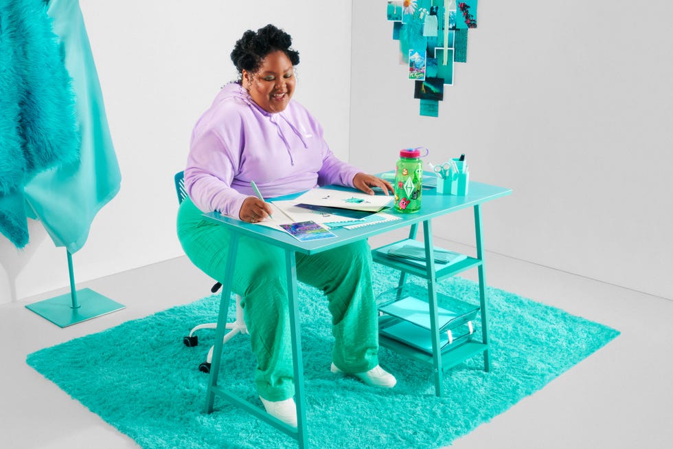 The Sims store with a person enjoying official products.