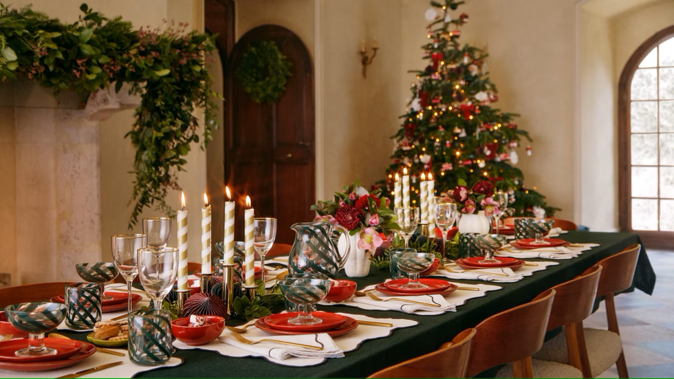 a table with a christmas tree and glasses on it