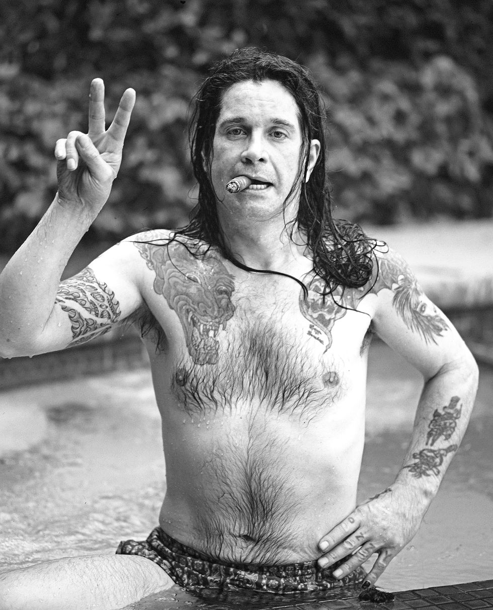 singer ozzy osborne in his pool with cigar at his beverly hills, california home in june 1987.