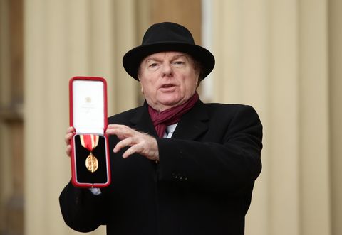 van morrison smiling with medal in honor of his knighthood