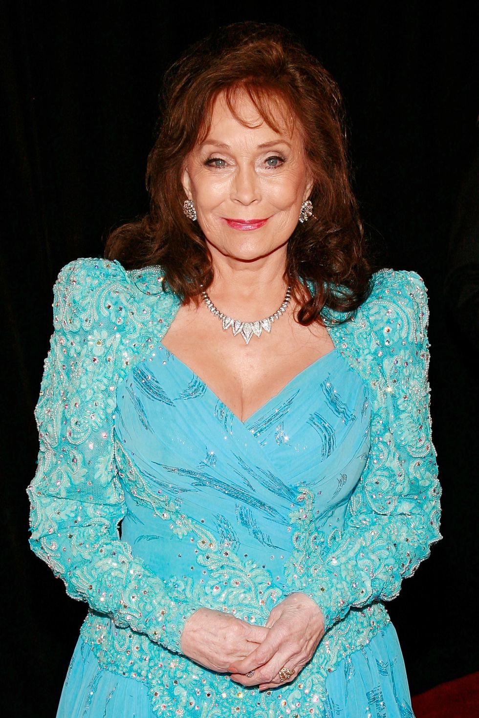 loretta lynn wearing a light blue dress and smiling for a photo