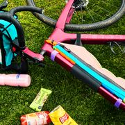 allied bike on grass with water bottle, snacks, bike bags, map