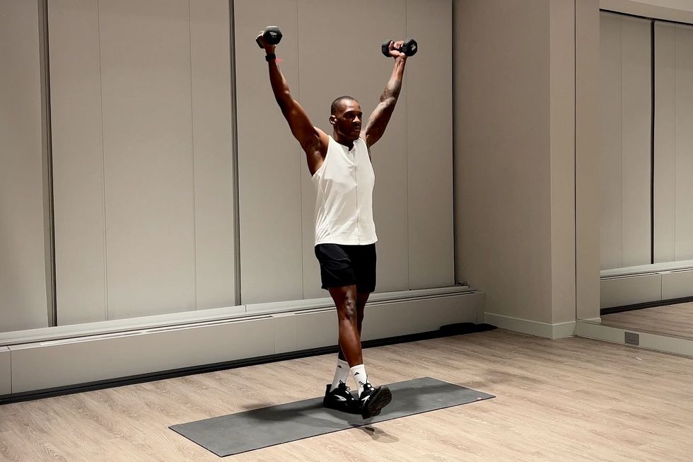 shoulder and arm workout, yusuf jeffers practices single leg scaption exercise