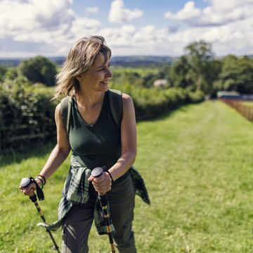 single mature woman hiking in the cotswolds, gloucestershire, united kingdom