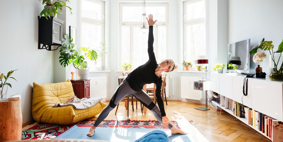single mom stretching doing yoga at home