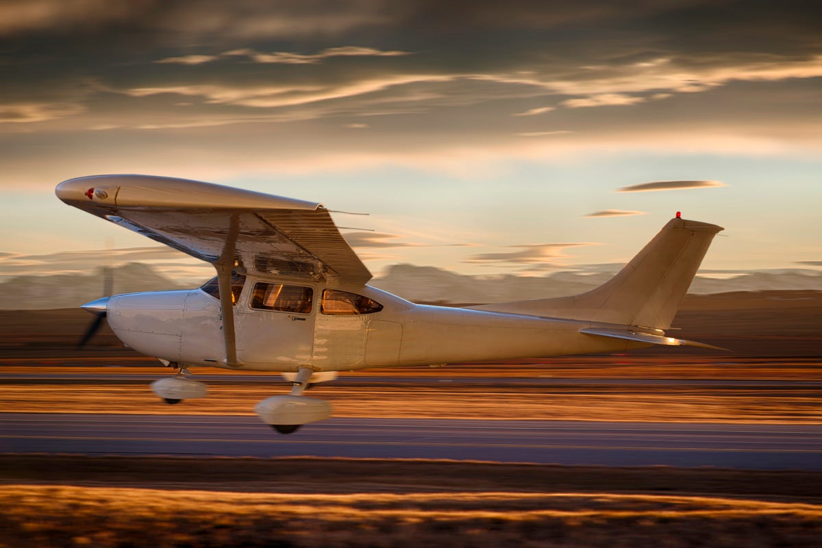 single prop plane during liftoff from airport